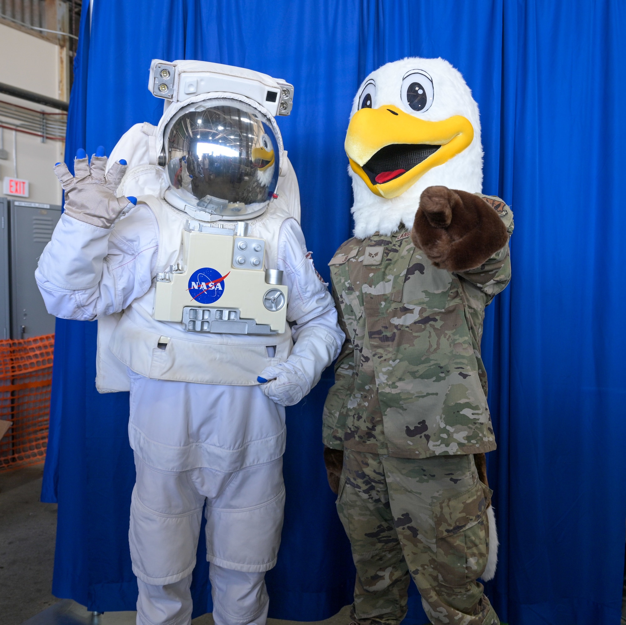 An Eagle Mascot poses with a NASA Astronaut mascot.