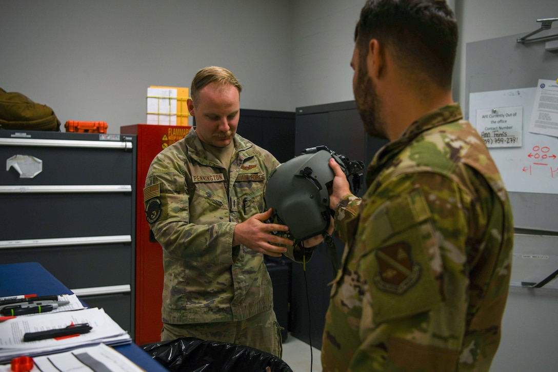 Service member receives a flight helmet.