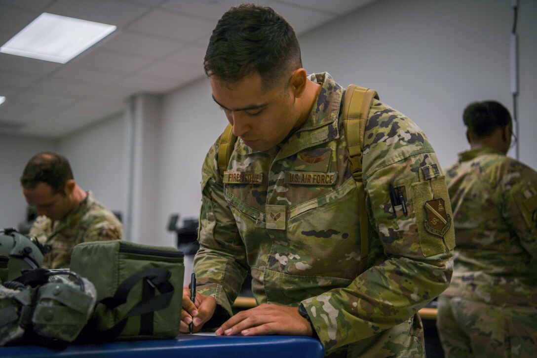 A service member writes a hand receipt.