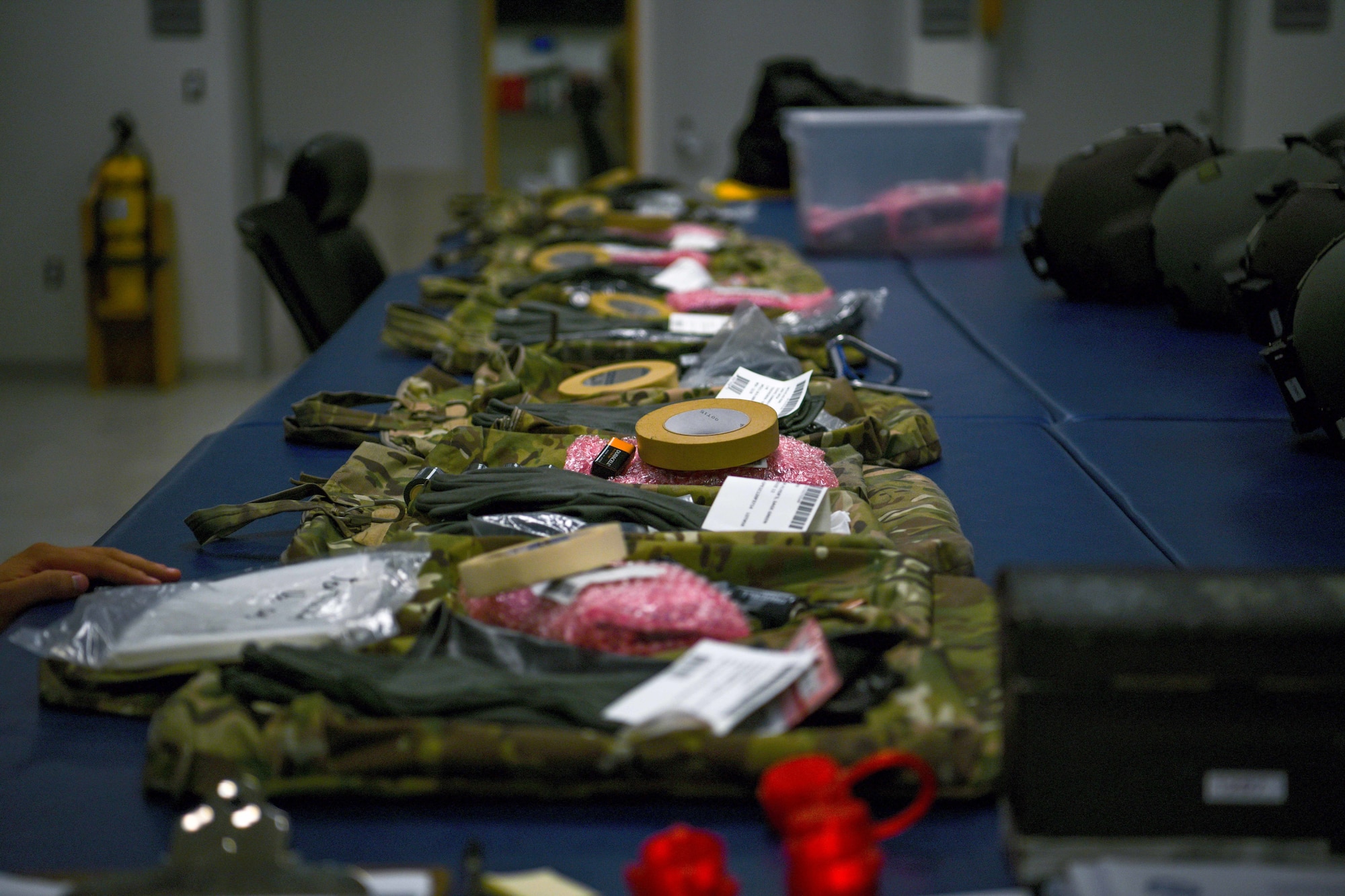 Military service bags lay on a counter.