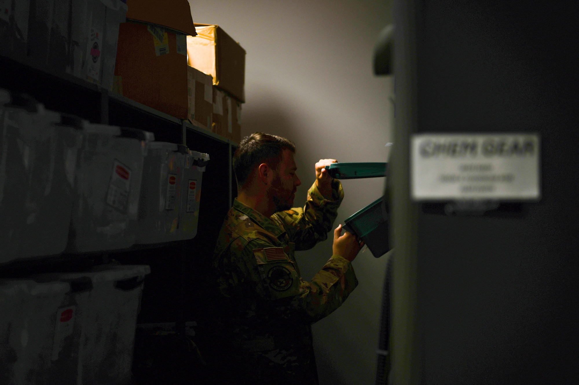 Airman looks in an equipment box.