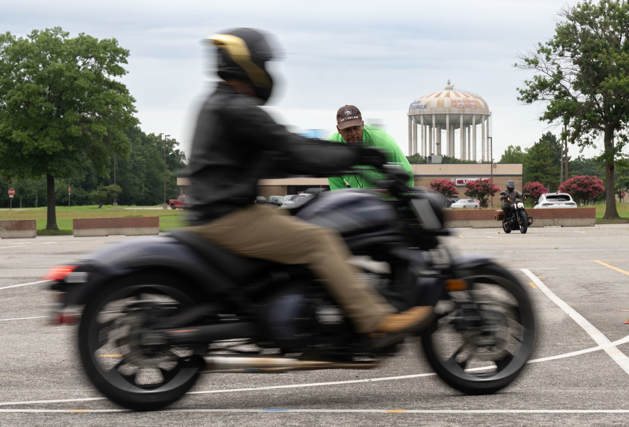 Daryl Bagley, Air Force District of Washington senior Motorcycle Safety Foundations rider coach, inspects rider maneuvers during a Basic RiderCourse 2 drill at Joint Base Andrews, Md., July 21, 2025.