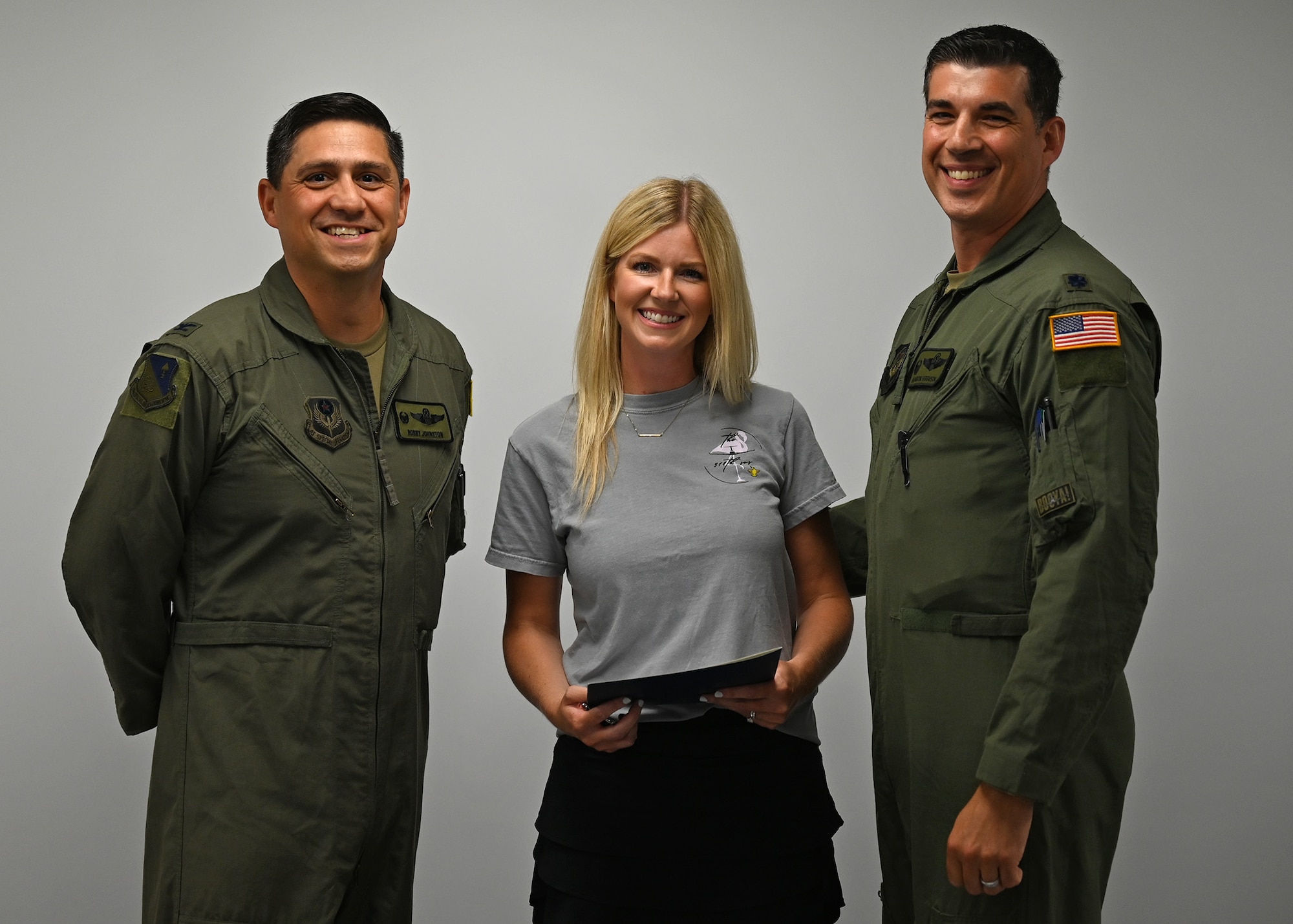 U.S. Air Force Col. Robert Johnston, left, 27th Special Operations Wing commander, and Lt. Col. Brandon Ferguson, right, a squadron commander assigned to the 27th SOW, present the Joan Orr Air Force Spouse of the Year award to Taylor Ferguson at at Cannon Air Force Base, New Mexico, July 18, 2025. Ferguson has made significant contributions to the families of Cannon AFB, the local community, as well as made an impact in shaping Department of Defense-level programs. (U.S. Air Force photo by Senior Airman Callie Norton)