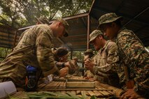 Malaysian Army soldiers demonstrate how to start a fire using natural materials found in the jungle, an essential survival skill shared with their Australian and U.S. Army partners during field training July 20, 2025.
