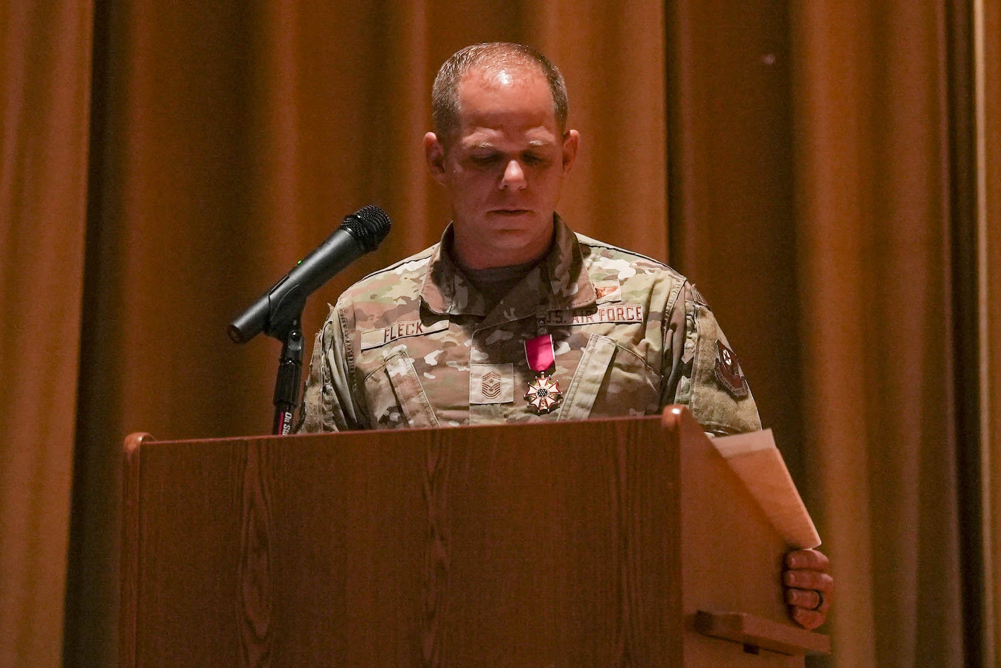 U.S. Air Force Chief Master Sgt. Colin Fleck, outgoing 27th Special Operations Wing command chief, delivers remarks during a change of responsibility ceremony at Cannon Air Force Base, New Mexico, July 21, 2025. Fleck said he leaves feeling fulfilled, but also melancholy, as he reflects on his time as the command chief – naming it the highest honor and privilege in his career thus far, serving at the most lethal and relevant wing in the United States Air Force. (U.S. Air Force photo by Staff Sgt. Kevin Williams)