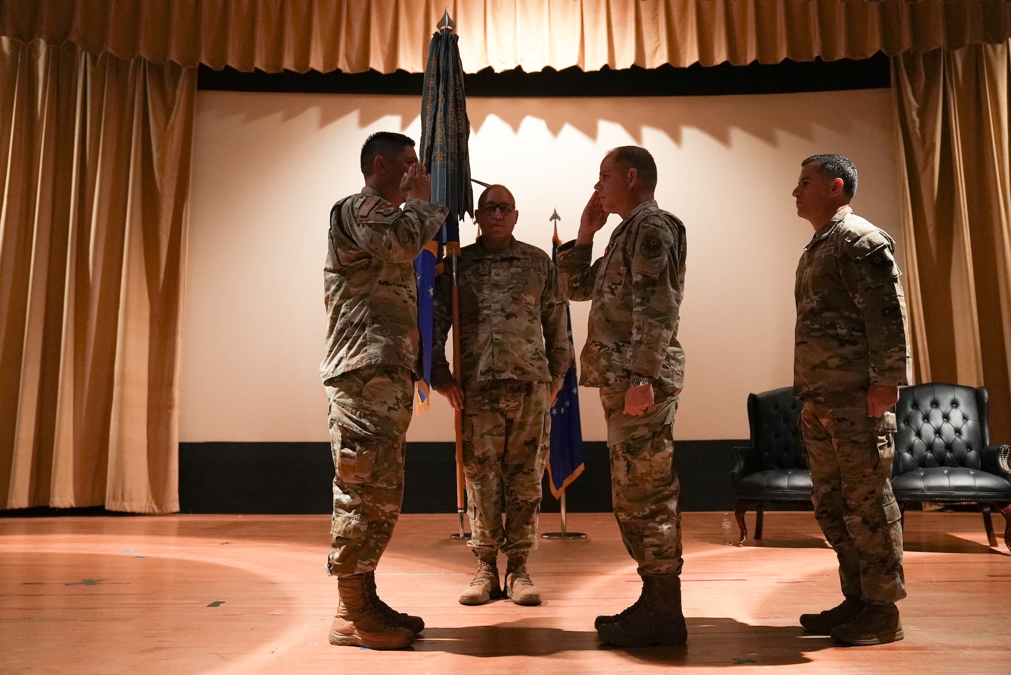 U.S. Air Force Chief Master Sgt. Colin Fleck (right), outgoing 27th Special Operations Wing command chief, salutes U.S. Air Force Col. Robert Johnston (left), 27th SOW commander, during a change of responsibility ceremony at Cannon Air Force Base, New Mexico, July 21, 2025. Fleck entered the Air Force in 2002 and has served as an aerial gunner on AC-130U and AC-130H gunships, as well as a sensor operator on the MQ-1B Predator and MQ-9 Reaper. (U.S. Air Force photo by Staff Sgt. Kevin Williams)