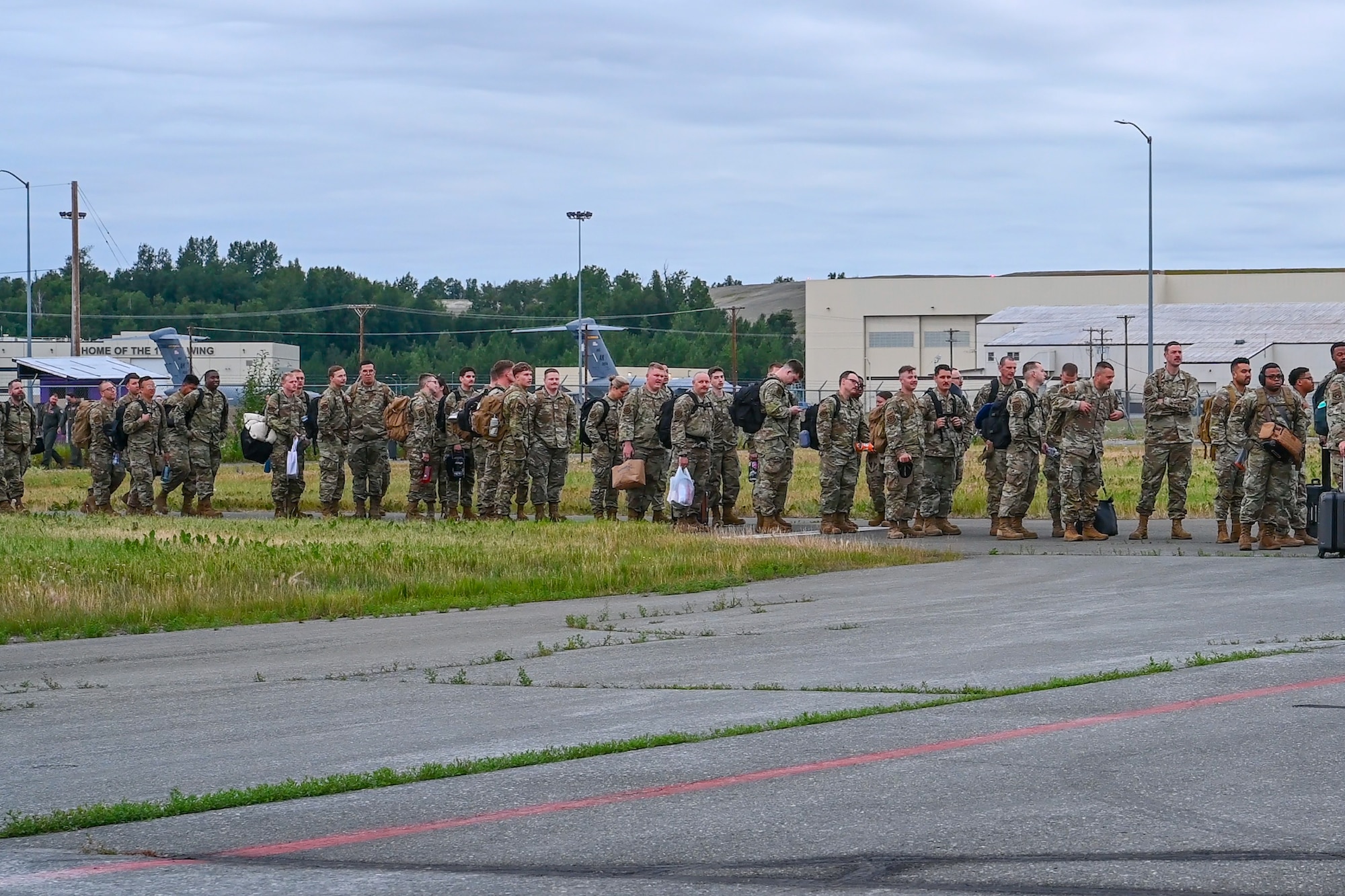 U.S. Air Force Airmen assigned to the 3rd Air Expeditionary Wing prepare to board an aircraft in support of exercise Resolute Force Pacific at Joint Base Elmendorf-Richardson, Alaska, July 13, 2025.