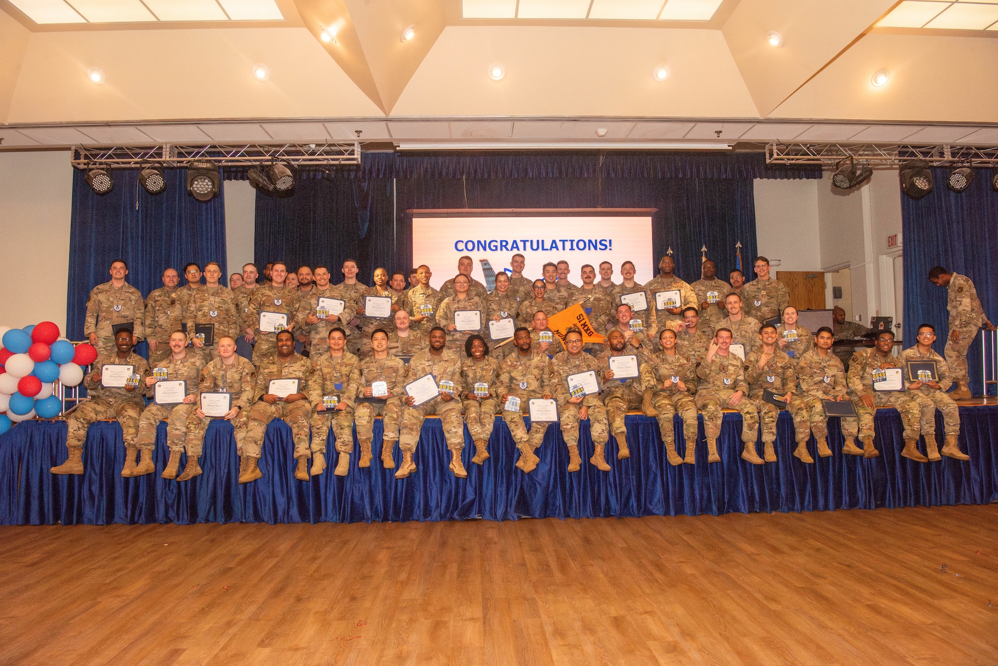 The newest technical sergeant selects pose for a group photo during the Technical Sergeant Release party at Osan Air Base, Republic of Korea, July 17, 2025.