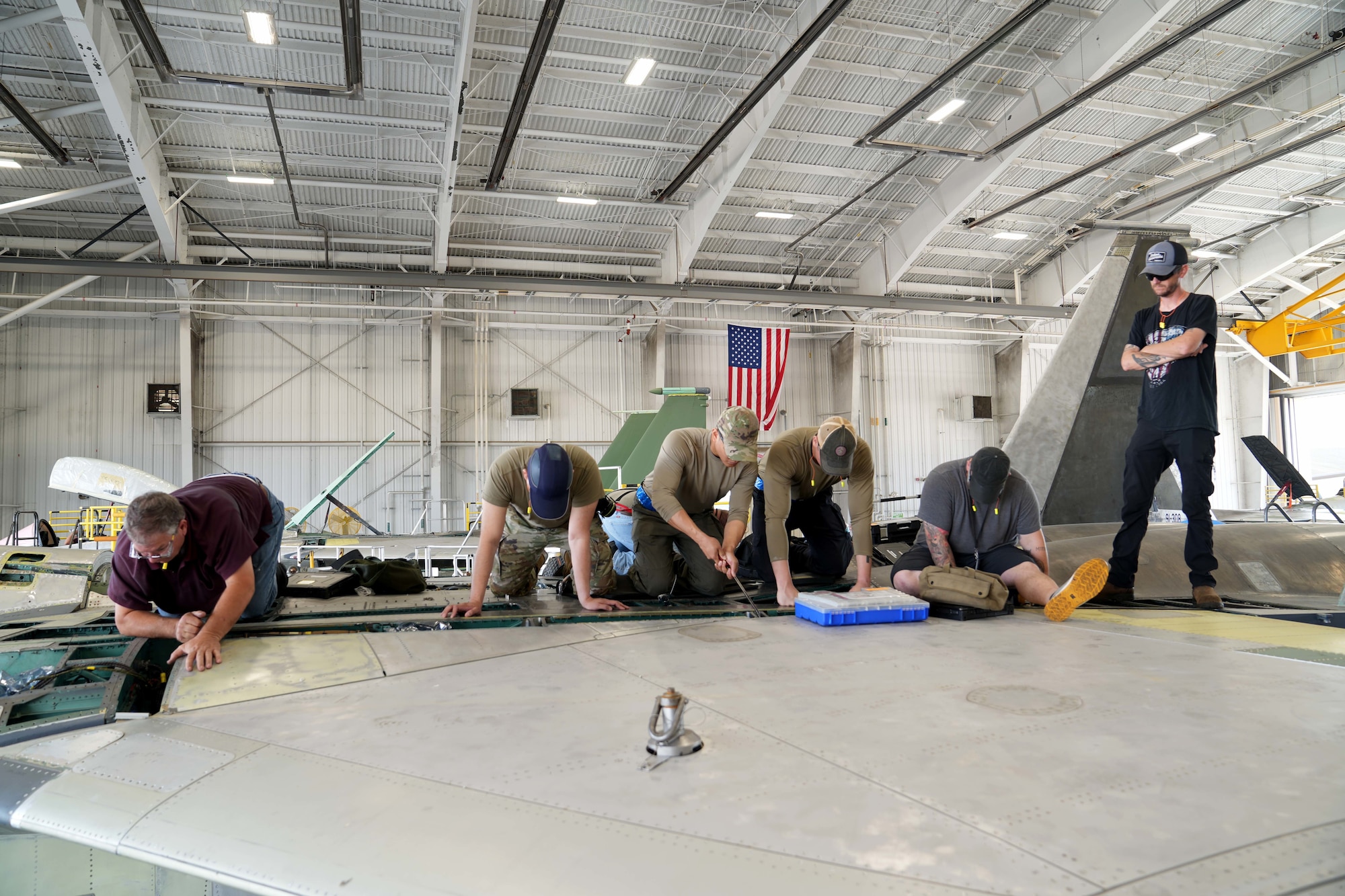mechanics working on a fighter aircraft