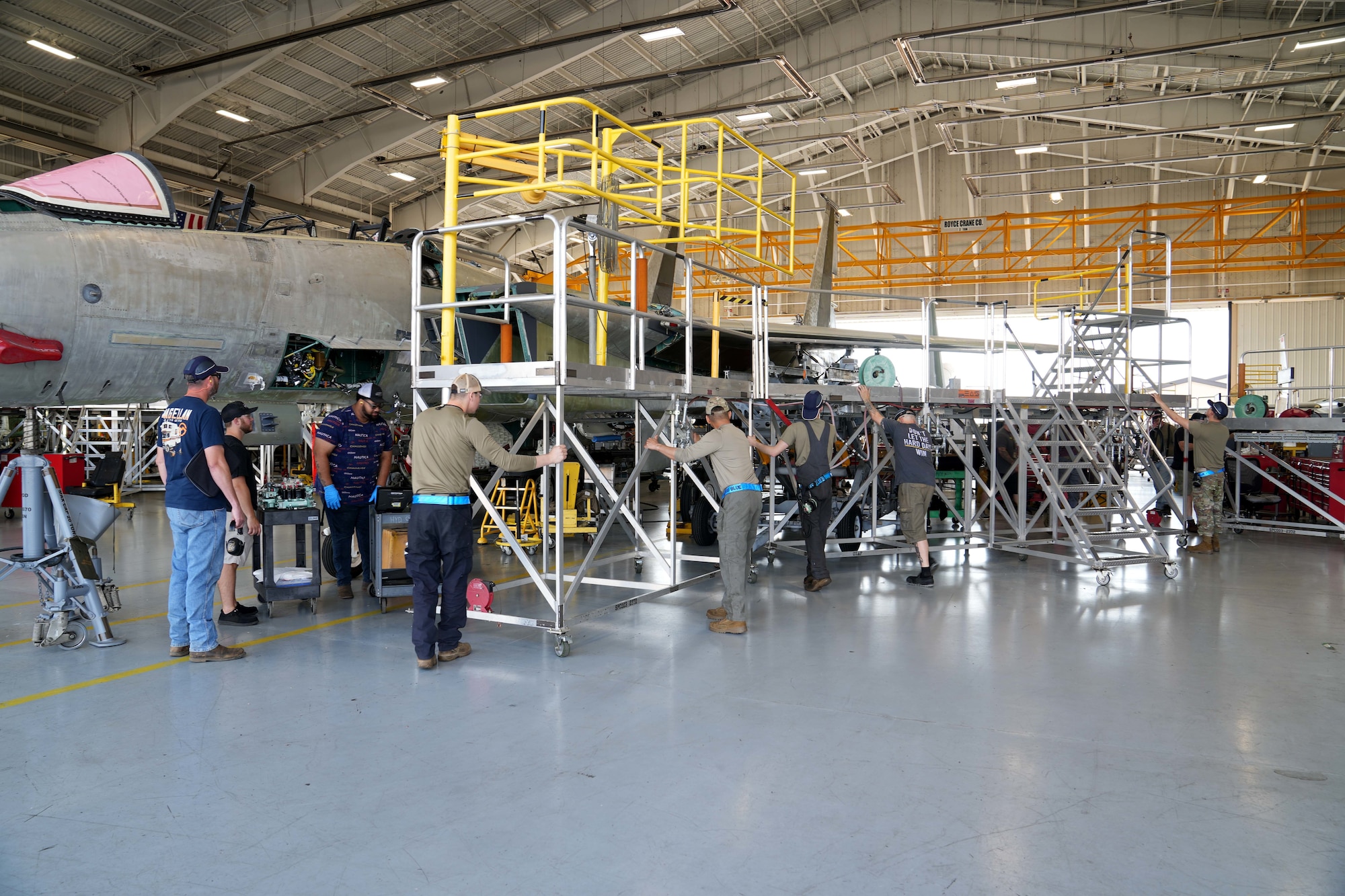 mechanics working on a fighter aircraft