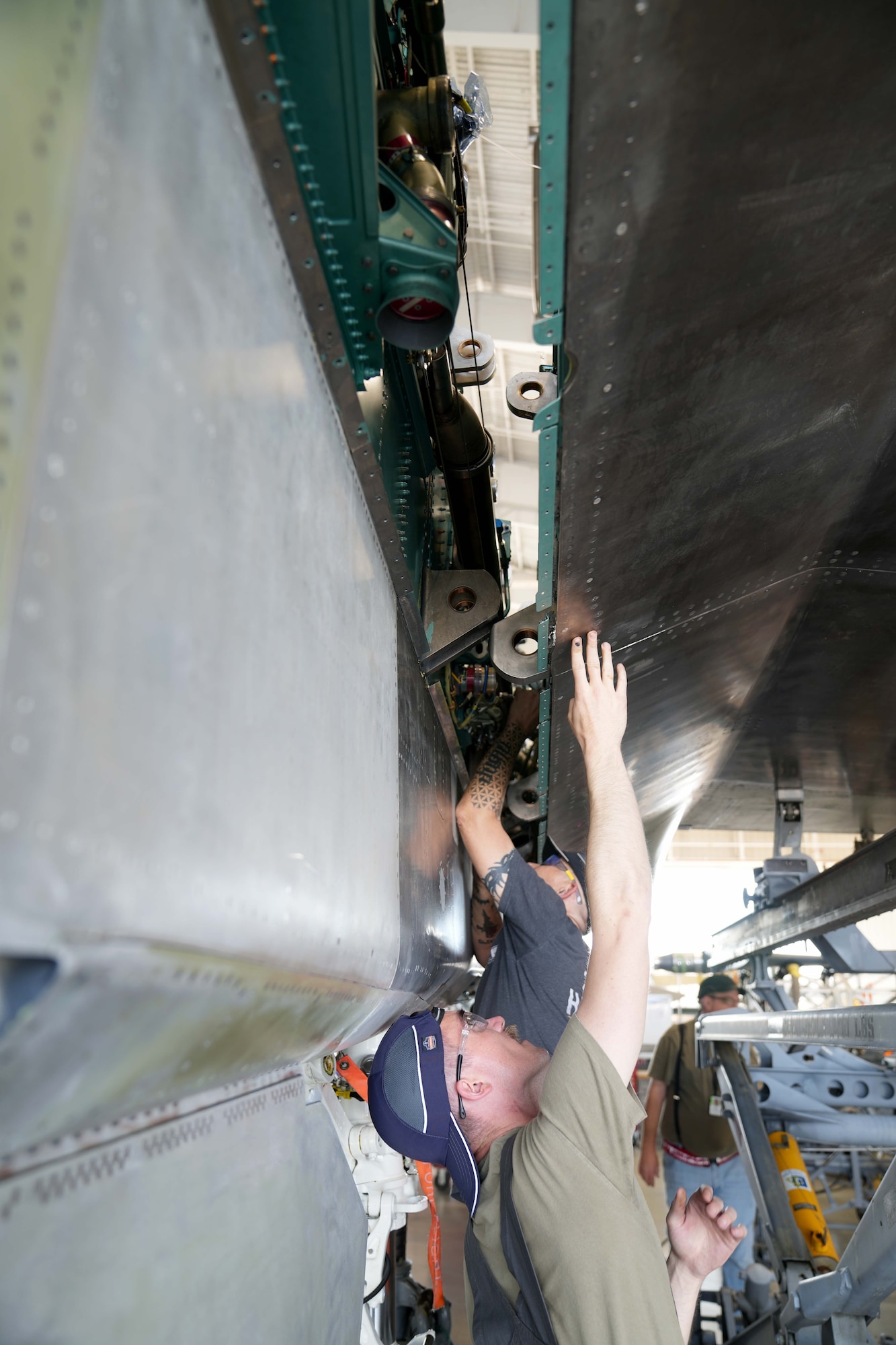 mechanics working on a fighter aircraft