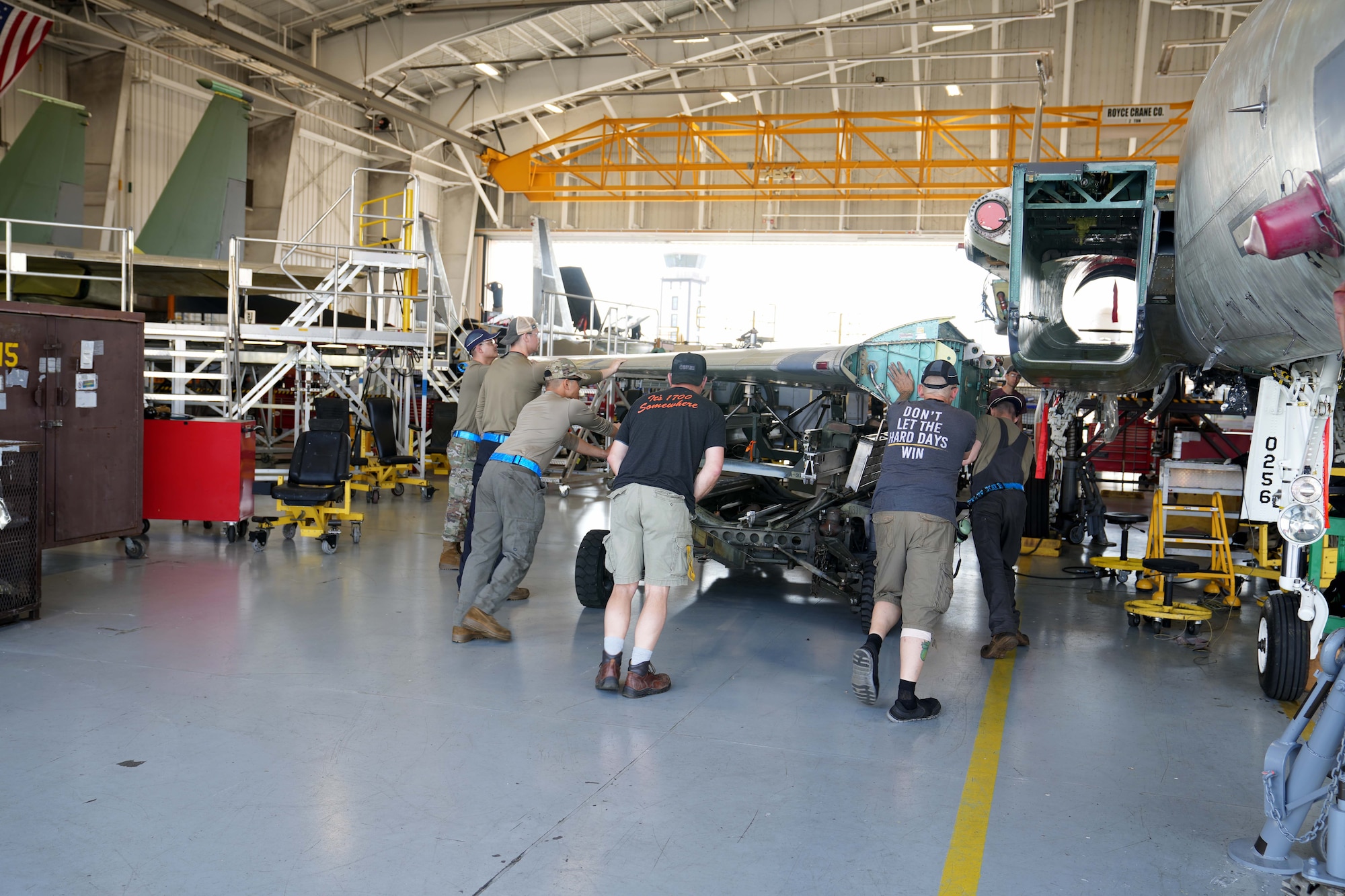 mechanics working on a fighter aircraft