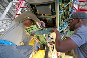 mechanics working on a fighter aircraft