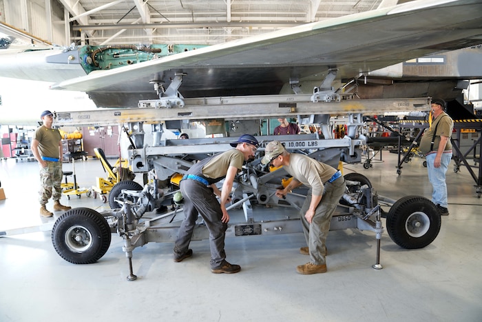 mechanics working on a fighter aircraft
