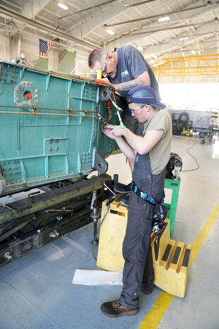 mechanics working on a fighter aircraft