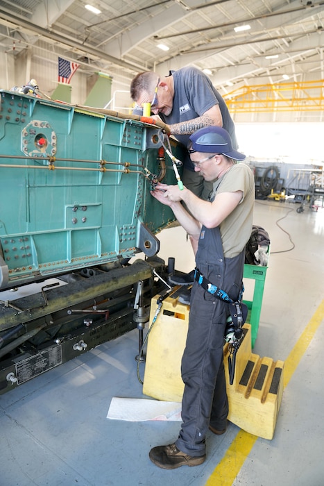 mechanics working on a fighter aircraft