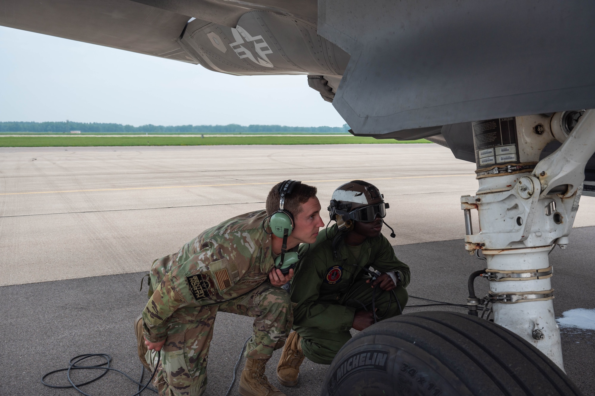 U.S. Air Force Senior Airmen Seth Hutchinson, 466th Aircraft Maintenance Unit crew chief (left) shows U.S. Marnie Private First Class Dylan Okwena, Marine Fighter Attack Squadron 225 powerline, plane captain (right), how the U.S. Air Force does a preflight inspection on an F-35A Lightning during Sentry North exercise at Volk Field Air National Guard Base, Wisconsin, June 12, 2025. Sentry North brought together units from across the Marines, Air and Army National Guard, Reserve, and active-duty forces reinforcing their collective defense capabilities.