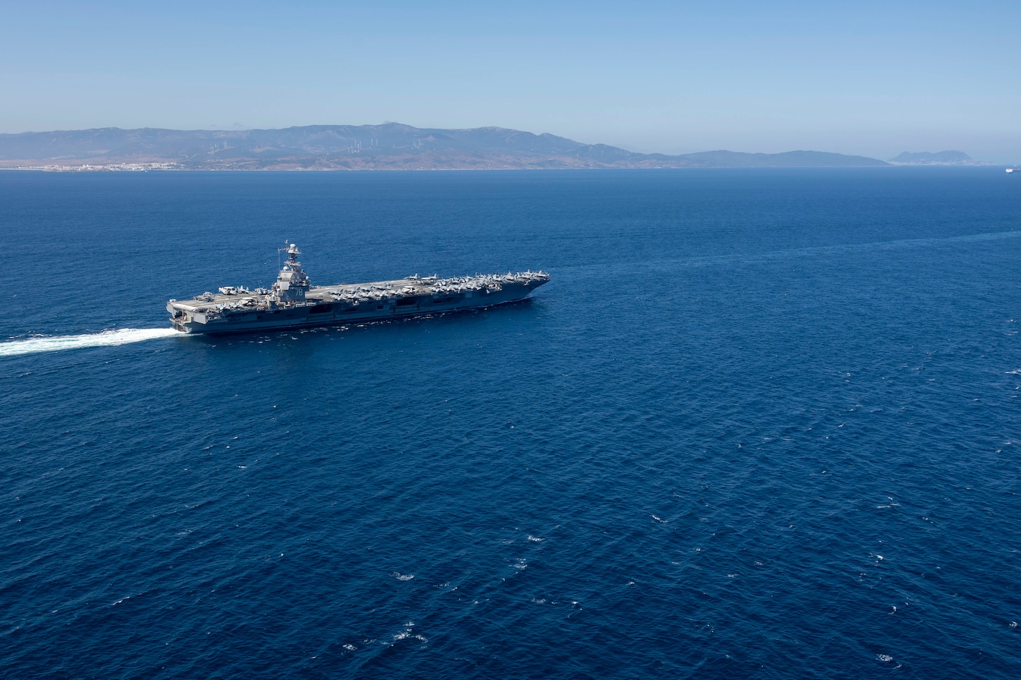 The world's largest aircraft carrier, USS Gerald R. Ford (CVN 78), transits the Strait of Gibraltar, July 17, 2025. Gerald R. Ford, a first-in-class aircraft carrier and deployed flagship of Carrier Strike Group Twelve, is on a scheduled deployment in the U.S. 6th Fleet area of operations to support the warfighting effectiveness, lethality, and readiness of U.S. Naval Forces Europe-Africa, and defend U.S., Allied and partner interests in the region. (U.S. Navy photo by Mass Communication Specialist 2nd Class Jacob Mattingly)