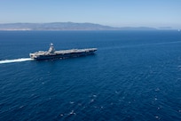 The world's largest aircraft carrier, USS Gerald R. Ford (CVN 78), transits the Strait of Gibraltar, July 17, 2025. Gerald R. Ford, a first-in-class aircraft carrier and deployed flagship of Carrier Strike Group Twelve, is on a scheduled deployment in the U.S. 6th Fleet area of operations to support the warfighting effectiveness, lethality, and readiness of U.S. Naval Forces Europe-Africa, and defend U.S., Allied and partner interests in the region. (U.S. Navy photo by Mass Communication Specialist 2nd Class Jacob Mattingly)