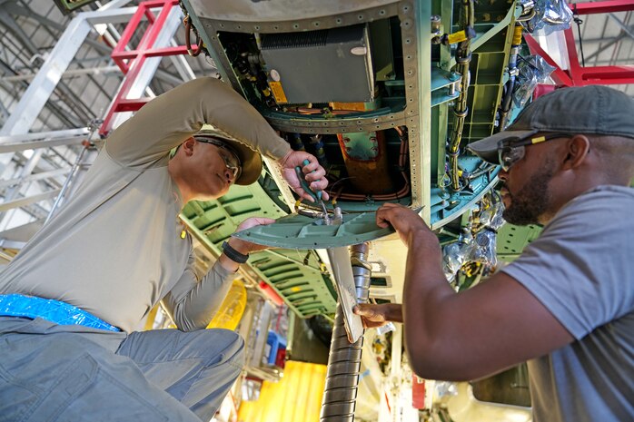 mechanics working on a fighter aircraft