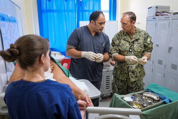 NUKU’ALOFA, Tonga (June 24, 2025) U.S. Navy Lt. Cmdr. Sean Foley, right, Critical Care Physician with Pacific Partnership 2025 (PP-25), and U.S. Navy Lt. Brittany Debow, left, Critical Care Nurse with PP-25, assist Dr. Richard Taumoepeau, a local physician, center, during an ultrasound-guided thoracentesis on a local patient at Vaiola Hospital as part of PP-25 in Nuku’Alofa, Tonga, June 24, 2025. Now in its 21st iteration, the Pacific Partnership series is the largest annual multinational humanitarian assistance and disaster management preparedness mission conducted in the Indo-Pacific. Pacific Partnership works collaboratively with host and partner nations to enhance regional interoperability and disaster response capabilities, increase security and stability in the region, and foster new and enduring friendships in the Indo-Pacific. (U.S. Navy photo by Courtesy Asset/Released)