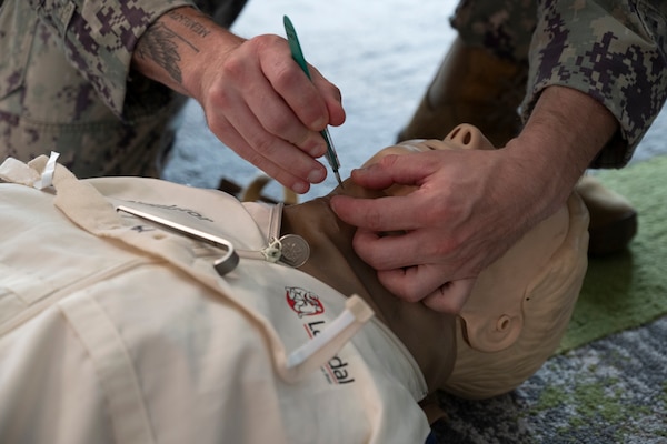 FORT LAUDERDALE, Fla. (July 12, 2025) Hospital Corpsman 2nd Class Gavyn Laforme, assigned to Navy Medicine Readiness and Training Command Pensacola, uses a manikin to demonstrate a cricothyrotomy during the "Top Doc" event at Nova Southeastern University's Fort Lauderdale campus. Navy Medicine and Navy Recruiting Command partnered with NSU to launch “Top Doc”, a national initiative connecting local medical professionals, educators, and students while highlighting Navy Medicine’s capabilities and career opportunities. (U.S. Navy Photo by Mass Communication Specialist 1st Class Natalia Murillo)