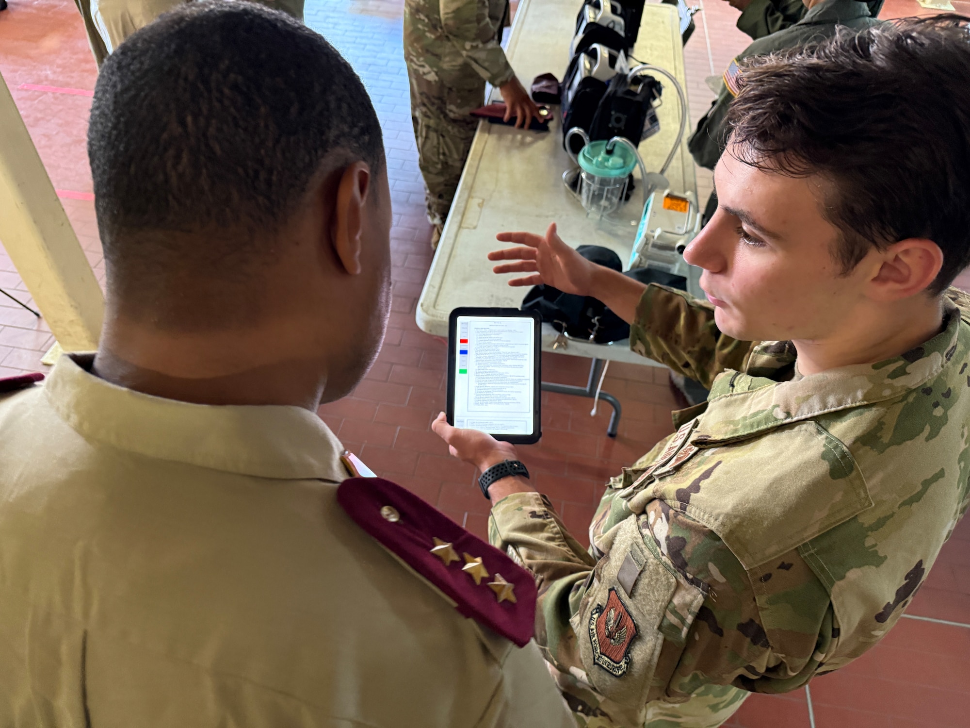 U.S. Air Force Staff Sgt. Hunter Marnelos, 86th Aeromedical Evacuation Squadron aeromedical evacuation technician, explains U.S. checklist procedures to an Algerian medical member during an Algerian aeromedical evacuation familiarization visit at Ramstein Air Base, Germany, July 17, 2025. The familiarization visit, led by the U.S. Air Forces in Europe – Air Forces Africa Command Surgeon’s Office of Global Health Engagements and the 86th Aeromedical Evacuation Squadron, provided an opportunity to exchange aeromedical training and best practices, serving as a foundation for future military healthcare cooperation.