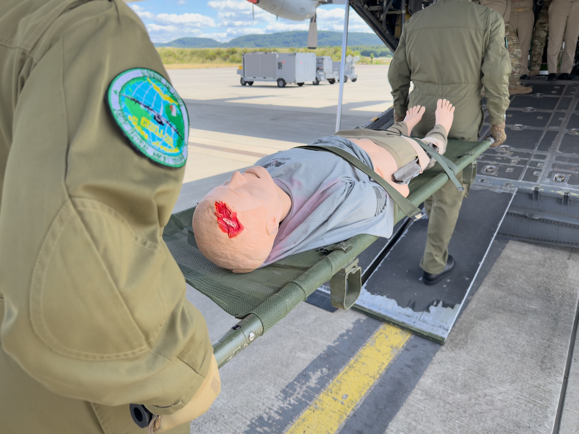 Algerian military personnel conduct a litter carry with a medical mannequin onto a static C-130 Hercules aircraft during an Algerian aeromedical evacuation familiarization visit at Ramstein Air Base, Germany, July 17, 2025. The familiarization visit, led by the U.S. Air Forces in Europe – Air Forces Africa Command Surgeon’s Office of Global Health Engagements and the 86th Aeromedical Evacuation Squadron, provided an opportunity to exchange aeromedical training and best practices, serving as a foundation for future military healthcare cooperation.