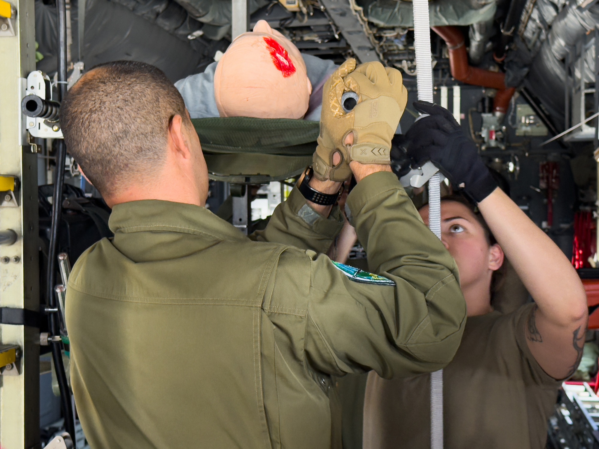 U.S. Air Force and Algerian aeromedical personnel secure a medical mannequin on a static C-130 Hercules during training as part of an Algerian aeromedical evacuation familiarization visit at Ramstein Air Base, Germany, July 17, 2025. The familiarization visit, led by the U.S. Air Forces in Europe – Air Forces Africa Command Surgeon’s Office of Global Health Engagements and the 86th Aeromedical Evacuation Squadron, provided an opportunity to exchange aeromedical training and best practices, serving as a foundation for future military healthcare cooperation.