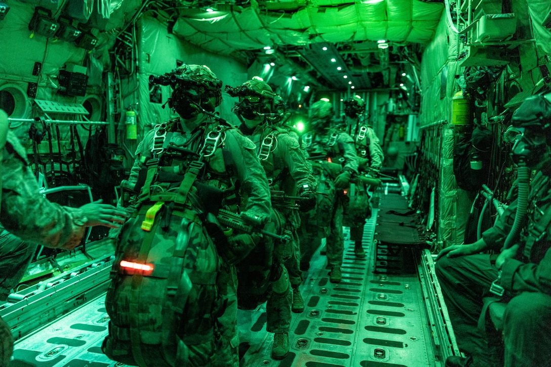 U.S. Marines with 2d Reconnaissance Battalion, 2d Marine Division prepare before a freefall jump during Service Level Training Exercise 4-25, on Marine Corps Air-Ground Combat Center, Twentynine Palms, California, July 18, 2025. SLTE 4-25 is designed to be a challenging, realistic training environment that produces combat-ready forces capable of operating as an integrated Marine Air Ground Task Force across all domains of military operations. (U.S. Marine Corps photo by Lance Cpl. Judith Ann Lazaro)