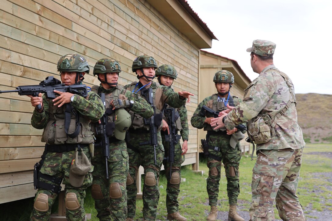 U.S. Army Maj. Ryan Hubbs receives a demonstration of urban operations from a team from the Ecuadorian Army in Latacunga, Ecuador, March 19, 2024.