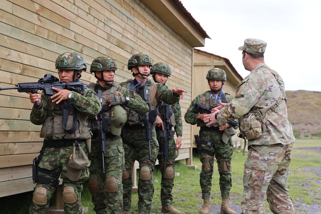 U.S. Army Maj. Ryan Hubbs receives a demonstration of urban operations from a team from the Ecuadorian Army in Latacunga, Ecuador, March 19, 2024.