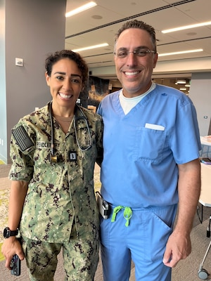 FORT LAUDERDALE, Fla. (July 12, 2025) Lt. Gahen Pendlebury, a full-time out-service medical officer and emergency medicine resident, left, poses for a photo with her former instructor, Dr. Aeyal Oren, a general surgeon and private practitioner in Plantation, during the "Top Doc" event held on at Nova Southeastern University's Fort Lauderdale campus. Navy Medicine and Navy Recruiting Command partnered with NSU to launch “Top Doc”, a national initiative connecting local medical professionals, educators, and students while highlighting Navy Medicine’s capabilities and career opportunities. (U.S. Navy Photo by Mass Communication Specialist 1st Class Natalia Murillo)