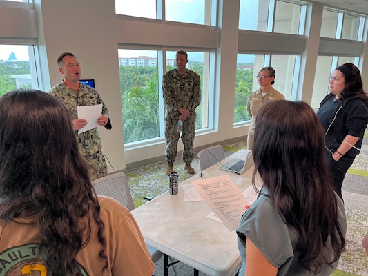 FORT LAUDERDALE, Fla. (July 12, 2025) Hospital Corpsman 1st Class Michael Dematti, assigned to Navy Talent Acquisition Group Miami, briefs on tactical evacuation care with participants of the "Top Doc" event held at Nova Southeastern University's Fort Lauderdale campus. Navy Medicine and Navy Recruiting Command partnered with NSU to launch the “Top Doc” event, a national initiative connecting local medical professionals, educators, and students while highlighting Navy Medicine’s capabilities and career opportunities. (U.S. Navy Photo by Mass Communication Specialist 1st Class Natalia Murillo)