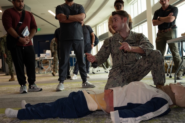 FORT LAUDERDALE, Fla. (July 12, 2025) Hospital Corpsman 2nd Class Gavyn Laforme, assigned to Navy Medicine Readiness and Training Command Pensacola, uses a manikin to demonstrate a Cricothyrotomy during the"Top Doc" event at Nova Southeastern University's Fort Lauderdale campus. Navy Medicine and Navy Recruiting Command partnered  with NSU to launch “Top Doc”, a national initiative connecting local medical professionals, educators, and students while highlighting Navy Medicine’s capabilities and career opportunities. (U.S. Navy Photo by Mass Communication Specialist 1st Class Natalia Murillo)