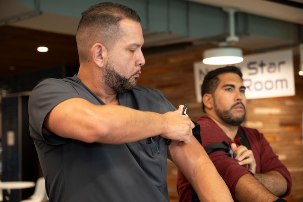 FORT LAUDERDALE, Fla. (July 12, 2025) Participants attempt to apply a tourniquet to themselves during the "Top Doc," event at Nova Southeastern University's Fort Lauderdale campus. Navy Medicine and Navy Recruiting Command partnered  with NSU to launch “Top Doc”, a national initiative connecting local medical professionals, educators, and students while highlighting Navy Medicine’s capabilities and career opportunities. (U.S. Navy Photo by Mass Communication Specialist 1st Class Natalia Murillo)