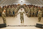 U.S. Army Maj. Troy Dandrea, brigade chaplain, 17th Sustainment Brigade (SB), prays over 17th SB Soldiers in the U.S. Central Command area of responsibility, Dec. 14, 2024.