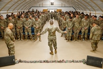 U.S. Army Maj. Troy Dandrea, brigade chaplain, 17th Sustainment Brigade, prays over Soldiers in the U.S. Central Command area of responsibility, Dec. 14, 2024.