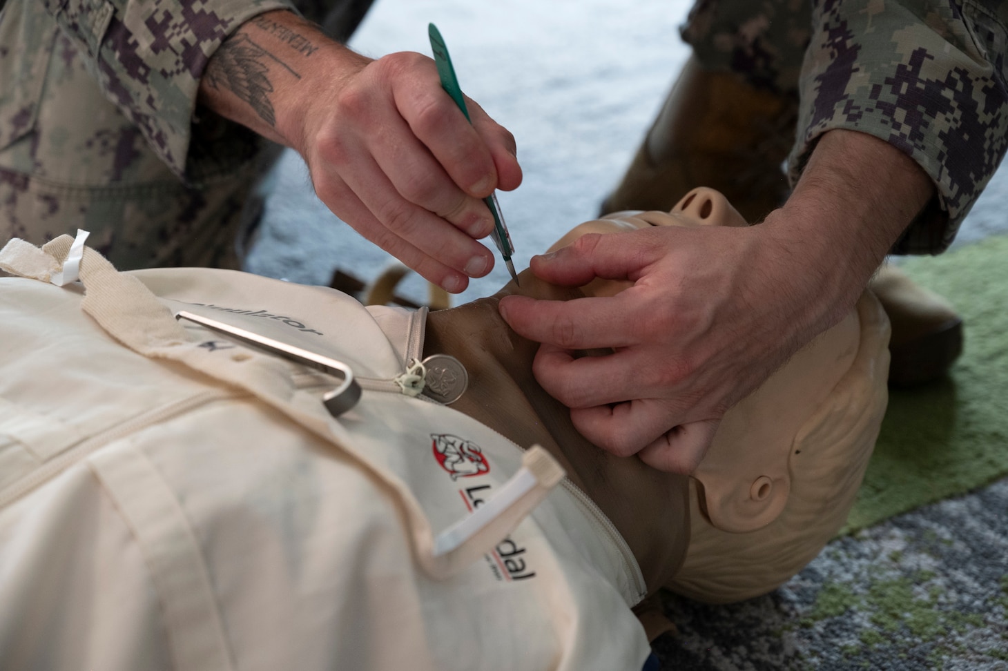 FORT LAUDERDALE, Fla. (July 12, 2025) Hospital Corpsman 2nd Class Gavyn Laforme, assigned to Navy Medicine Readiness and Training Command Pensacola, uses a manikin to demonstrate a cricothyrotomy during the "Top Doc" event at Nova Southeastern University's Fort Lauderdale campus. Navy Medicine and Navy Recruiting Command partnered with NSU to launch “Top Doc”, a national initiative connecting local medical professionals, educators, and students while highlighting Navy Medicine’s capabilities and career opportunities. (U.S. Navy Photo by Mass Communication Specialist 1st Class Natalia Murillo)