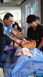 FORT LAUDERDALE, Fla. (July 12, 2025) —Dr. Aeyal Oren, a general surgeon and private practitioner in Plantation, left, uses a Tactical Combat Casualty Care Cut Suit to show internal organs during the “Top Doc” event at Nova Southeastern University’s Fort Lauderdale campus. Navy Medicine and Navy Recruiting Command partnered with NSU to launch “Top Doc”, a national initiative connecting local medical professionals, educators, and students while highlighting Navy Medicine’s capabilities and career opportunities. (U.S. Navy Photo by Mass Communication Specialist 1st Class Natalia Murillo)