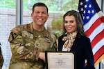 Hospital commander handing certificate to employee at the Hospital Awards Ceremony.