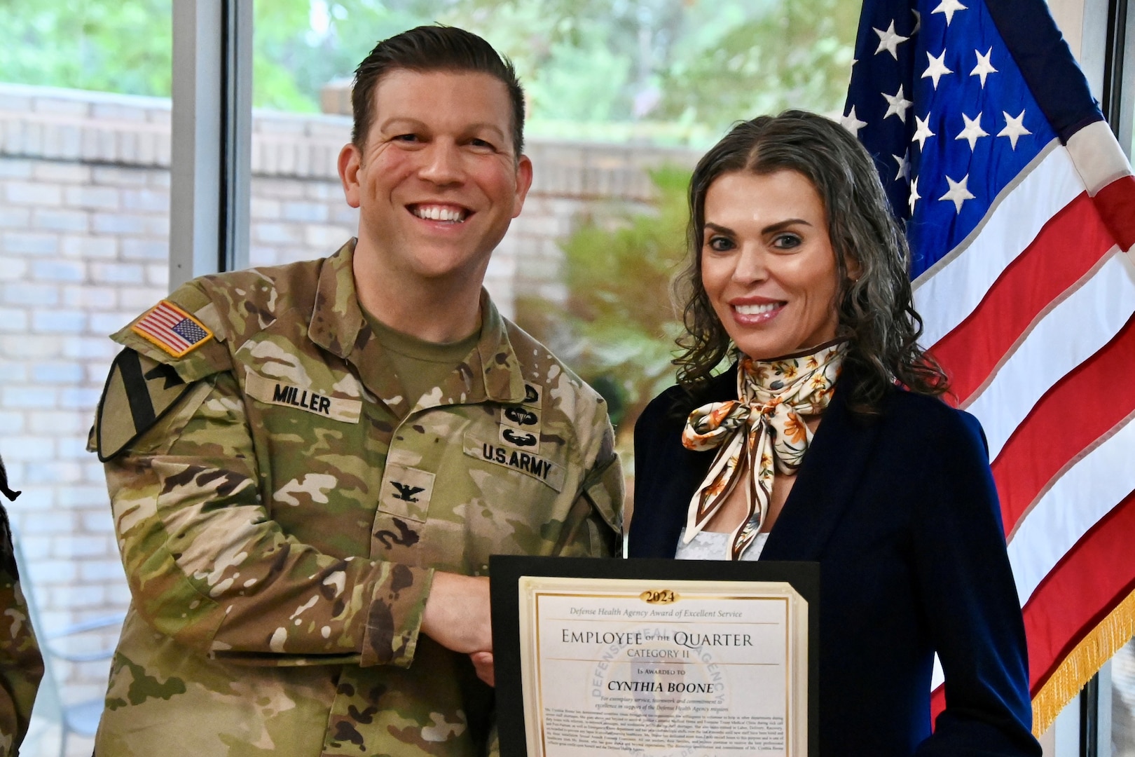 Hospital commander handing certificate to employee at the Hospital Awards Ceremony.