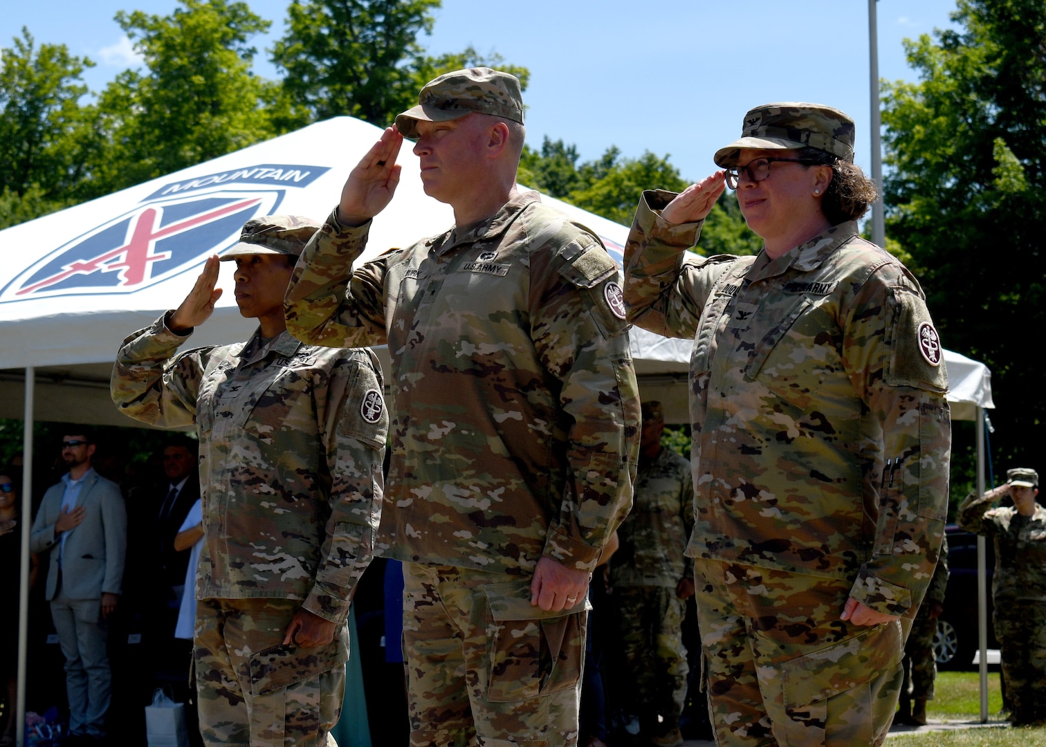 Col. Christina M. Buchner, left, outgoing commander of the U.S. Army Medical Department Activity (MEDDAC) – Fort Drum, Brig. Gen. James D. Burk, center, commanding general of the U.S. Army Medical Readiness Command, East, and Col. Elizabeth H. Duque, incoming commander of the Fort Drum MEDDAC, salute the unit’s color guard during a change of command ceremony at Fort Drum, N.Y., July 18, 2025.