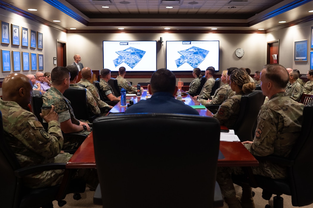 U.S. Coast Guard Rear Adm. Greg Rothrock, U.S. Cyber Command J7 Director of Force Development, and U.S. Air Force Chief Master Sgt. Kenneth Bruce, Command Senior Enlisted Leader, USCYBERCOM and Director's Senior Enlisted Advisor, National Security Agency/Commander’s Support Staff, receive the 17th Training Wing Mission Brief at the Norma Brown headquarters building, Goodfellow Air Force Base, Texas, May 20, 2025. The Wing Mission Brief introduces visitors to each of the groups and squadrons that fall under the 17th TRW, including geographically separated units, and explains how their operations support the mission. (U.S. Air Force photo by Airman 1st Class Brian Lummus)