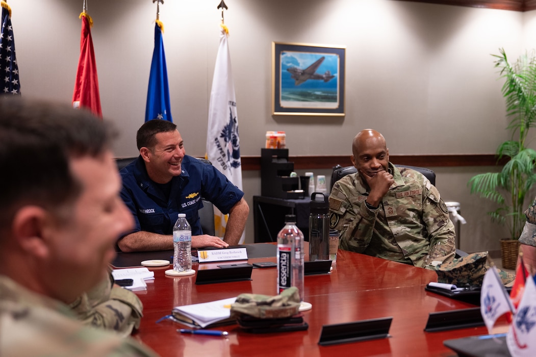 U.S. Coast Guard Rear Adm. Greg Rothrock, U.S. Cyber Command J7 Director of Force Development, and U.S. Air Force Chief Master Sgt. Kenneth Bruce, Command Senior Enlisted Leader, USCYBERCOM and Director's Senior Enlisted Advisor, National Security Agency/Commander’s Support Staff, discuss the joint training environment with 17th Training Wing Leadership during the 17th TRW mission brief at the Norma Brown headquarters building, Goodfellow Air Force Base, Texas, May 20, 2025. The Wing Mission Brief allowed for RDML Rothrock and CMSgt Bruce to better understand how Goodfellow integrates joint intelligence, reconnaissance and surveillance warriors to build a foundational standard across the ISR community. (U.S. Air Force photo by Airman 1st Class Brian Lummus)
