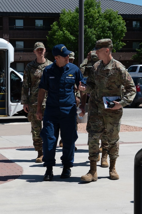 U.S. Coast Guard Rear Adm. Greg Rothrock, U.S. Cyber Command J7 Director of Force Development, and U.S. Air Force Col. Thomas “TK” Wilson, 17th Training Wing deputy commander, walk to the Cressman Dining Facility at Goodfellow Air Force Base, Texas, May 20, 2025. RDML Rothrock ate lunch with training personnel to gain insight and direct engagement with the instructors that directly train the next generation of intelligence, surveillance and reconnaissance warriors. (U.S. Air Force photo by Airman 1st Class Brian Lummus)