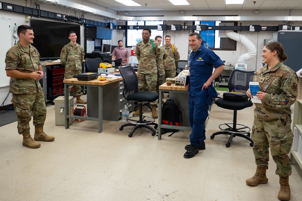 U.S. Coast Guard Rear Adm. Greg Rothrock, U.S. Cyber Command J7 Director of Force Development, is briefed on the capabilities of students attached to the 312th Training Squadron by U.S. Air Force Maj. Cristina Behrens, 312th TRS director of operations, and Staff Sgt. Aaron Leitschuh, 312th TRS scientific application specialist, at the Louis F. Garland Department of Defense Fire Academy, Goodfellow Air Force Base, Texas, May 20, 2025. RDML Rothrock learned how Airmen in the Special Instruments Training course study at Goodfellow before deploying to austere locations, where they are expected to perform their duties independently, functioning with the responsibilities of multiple Air Force Specialty codes to accomplish the mission. (U.S. Air Force photo by Airman 1st Class Brian Lummus)