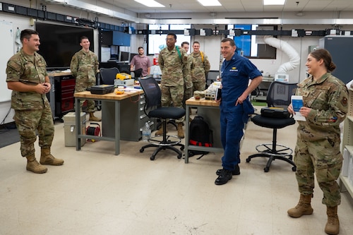 U.S. Coast Guard Rear Adm. Greg Rothrock, U.S. Cyber Command J7 Director of Force Development, is briefed on the capabilities of students attached to the 312th Training Squadron by U.S. Air Force Maj. Cristina Behrens, 312th TRS director of operations, and Staff Sgt. Aaron Leitschuh, 312th TRS scientific application specialist, at the Louis F. Garland Department of Defense Fire Academy, Goodfellow Air Force Base, Texas, May 20, 2025. RDML Rothrock learned how Airmen in the Special Instruments Training course study at Goodfellow before deploying to austere locations, where they are expected to perform their duties independently, functioning with the responsibilities of multiple Air Force Specialty codes to accomplish the mission. (U.S. Air Force photo by Airman 1st Class Brian Lummus)