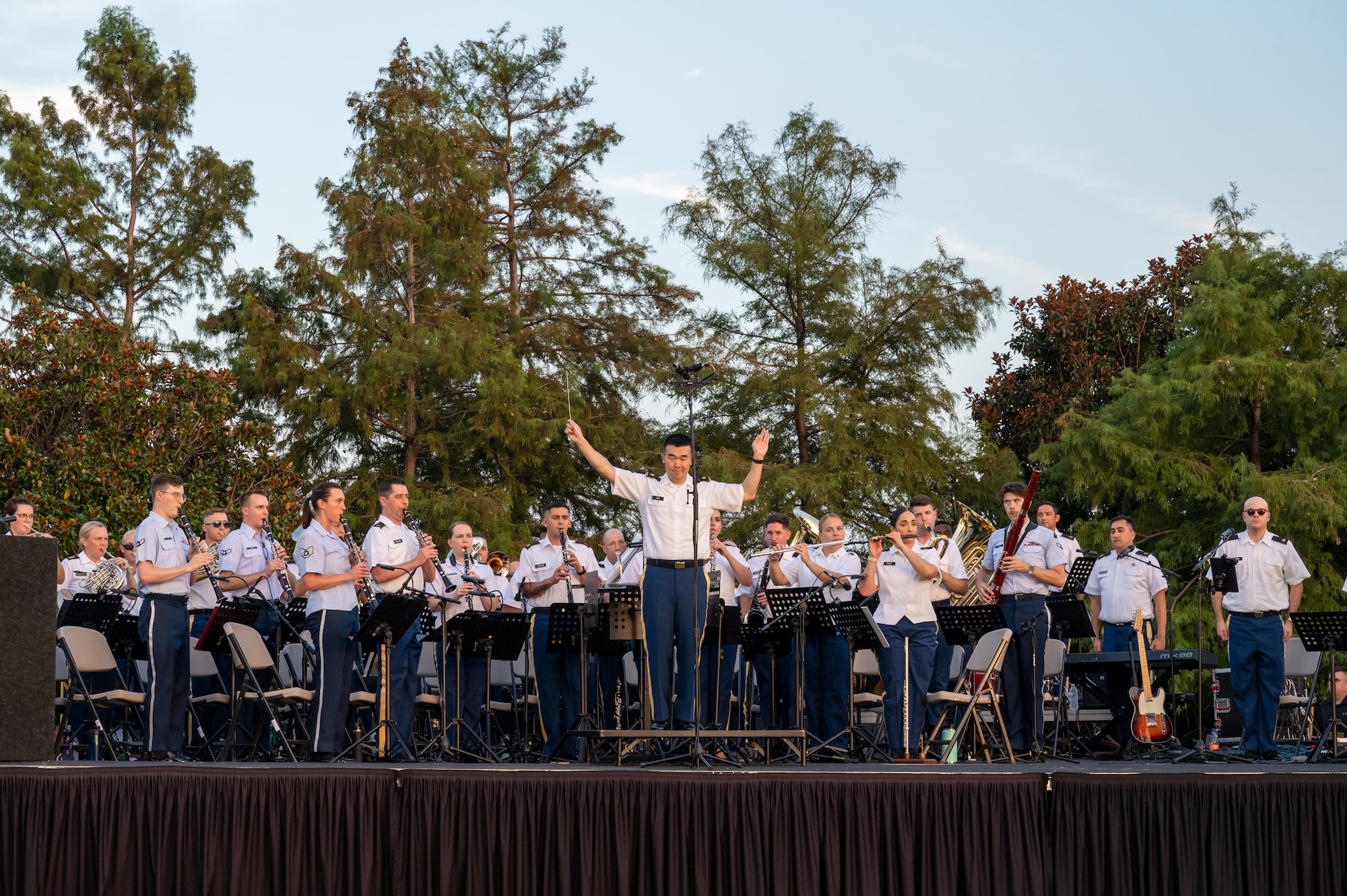 A band sits behind the band conductor.