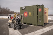 Corrosion prevention and control equipment is displayed in front of a Corrosion Prevention and Control (CPAC) Mobile Service Container.